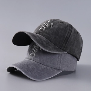 Detail of high-quality flying turtle embroidery on washed cotton baseball caps