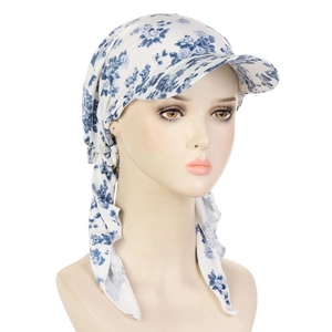 Detail of blue floral print headscarf with brim and tie-back knot on a mannequin