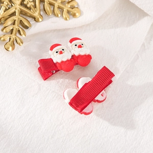 Pair of festive Christmas Santa Claus hair clips with red ribbon wrap for party styling