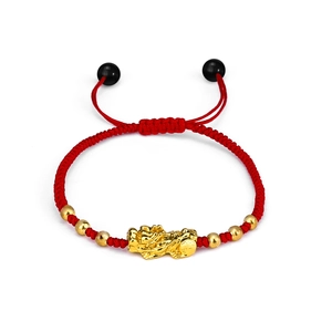 Detailed view of red woven bracelet featuring golden PiXiu and metallic bead accents