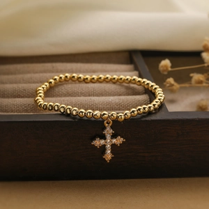 Gold plated beaded bracelet with zircon cross pendant on elegant jewelry box