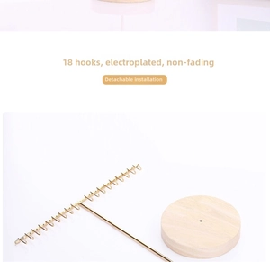 Detail of detachable golden T-bar jewelry rack with 18 hooks and a round wooden base