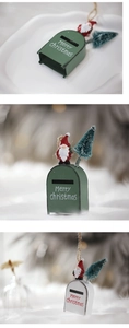 Miniature Christmas mailbox ornament with Santa and pine tree detail on snowy background
