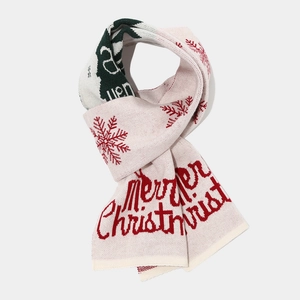 Detail of Christmas knitted scarf with snowflake patterns and Merry Christmas text