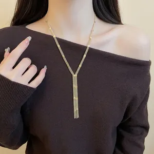 Elegant multi-layer gold Y-shaped tassel necklace with decorative cubes on model