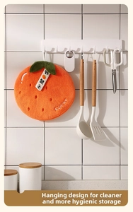 Macro detail of the orange-shaped hanging coral fleece hand towel with LUCKY embroidery