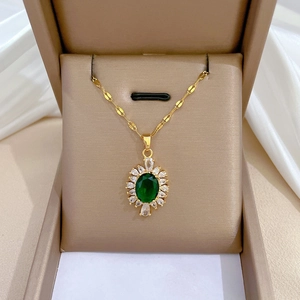 Luxury titanium steel necklace with green oval gemstone pendant in a beige jewelry box