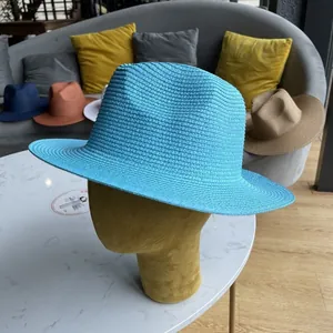 Detailed texture of blue woven straw Panama hat with spiral pattern on a mannequin head
