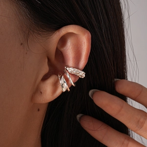 Close-up of three pieces set metallic irregular geometric ear cuffs worn on ear