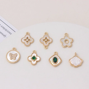 Macro shot of gold-plated shell and zircon charms for DIY jewelry making sets