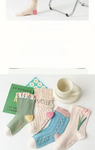 Detailed embroidery of tulips and floral textures on vintage style cotton crew socks