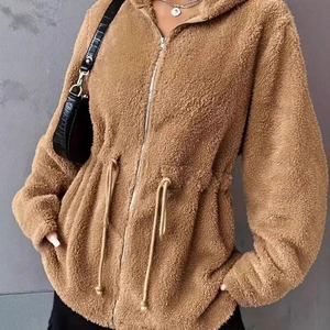 Detailed texture of brown fuzzy fleece jacket with drawstring waist and zipper design
