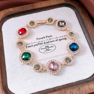 Vintage gold bracelet with multi-colored square gemstones and sparkling crystal pavé