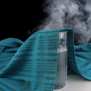 Absorbent lightweight bathrobe showing high breathability with steam through dark cyan fabric