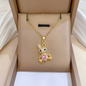 Macro view of crystal rabbit pendant with pink heart gemstone in jewelry box