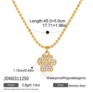 Detailed view of stainless steel ball chain necklace with white zircon paw pendant