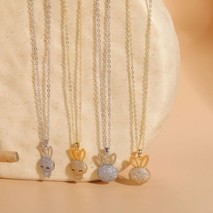 Close-up of four cute rabbit pendant necklaces with cubic zirconia in gold and silver