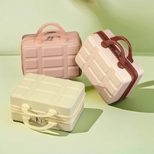 Three stacked macaron-colored hard shell vanity cases with textured grid surface and side shadows