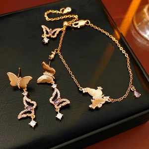 Gold-plated butterfly jewelry set with purple crystals including necklace and earrings