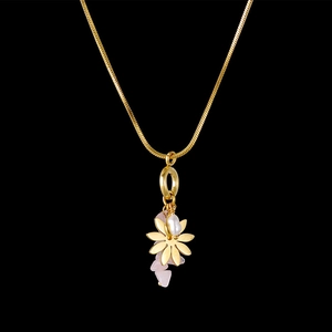 Detail of gold snake chain necklace with pink natural stone and pearl pendant