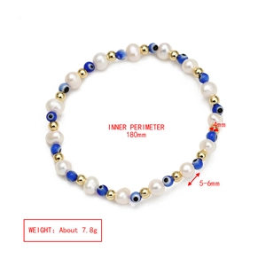 Macro view of blue evil eye beads with white pearls and gold spacers on 180mm bracelet