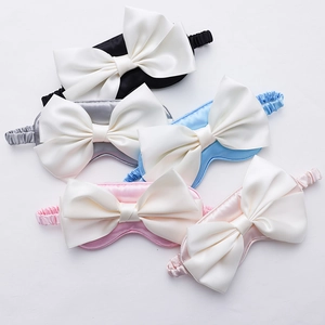 Silk-like satin sleep masks with large bow design in multiple colors on white background