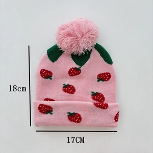 Close-up of pink knit hat with strawberry pattern, measuring 18cm height by 17cm width