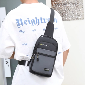 Men's casual black-grey crossbody chest bag in oxford cloth shown on back by a model