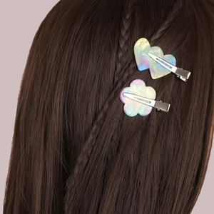 Floral and heart acetate hair clips set shown on model with iridescent finish effect