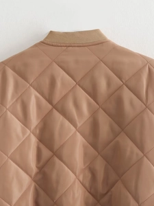 Close-up of khaki quilted jacket featuring ribbed collar and diamond stitch patterns