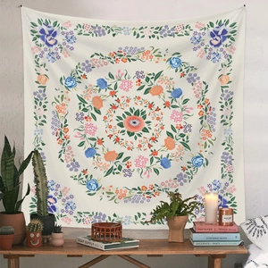 Detail of bohemian mandala tapestry featuring floral patterns on a cozy room wall