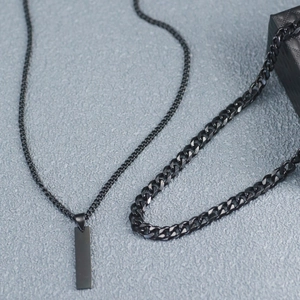 Detail of black double-layered Cuban chain necklace with a rectangular pendant