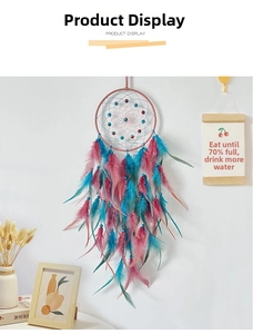 Handmade dreamcatcher featuring pink and blue feathers with woven net for wall decor