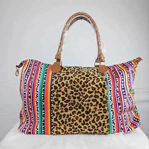 Large canvas travel weekender bag with leopard print, colorful stripes and brown leather trim