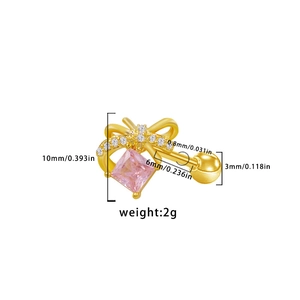 Macro view of gold bow earring with pink square stone and white crystals details
