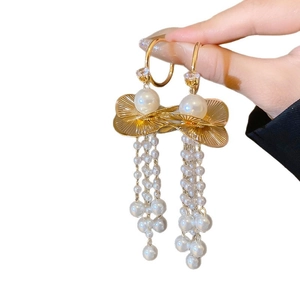 Elegant gold pearl drop earrings with fan texture and tassel fringe on white background