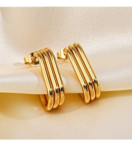 Detailed macro view of 18K gold plated triple layered U-shaped stainless steel earrings