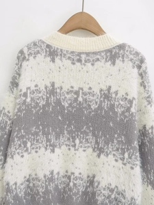 Detailed close-up of fuzzy grey and white gradient striped mohair sweater knit texture