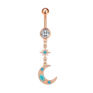 Detail of rose gold belly ring with star and moon charms featuring blue and clear zircon