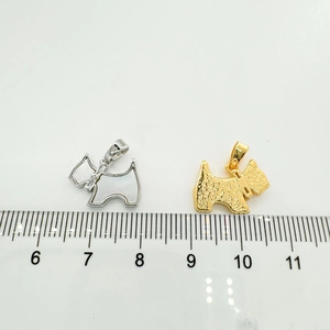 Detailed view of Scottish Terrier pendants in gold and silver with ruler for size reference