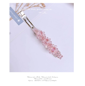 Detail of pink crystal beaded hair clip with silver-tone metal and faceted cutting