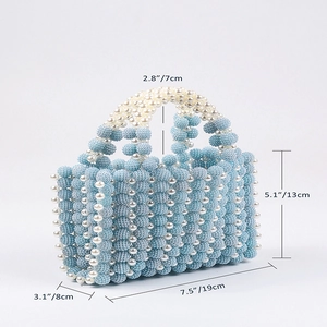 Detail showing hand-woven blue beads and white pearls on mini handbag with dimensions