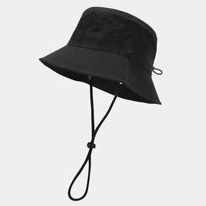 Detail of adjustable drawstring and windproof chin strap on waterproof bucket hat