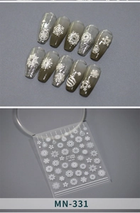 Detail of winter snowflake nail stickers with white Christmas patterns on grey nails