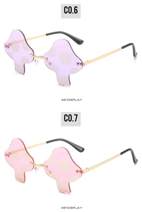 Detail view of purple and pink rimless mushroom sunglasses with gold metal temples