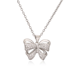 Silver bow pendant necklace with shimmering zircon stones on a white background