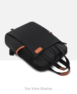 Top view of black waterproof laptop backpack with brown leather handles and zipper pulls