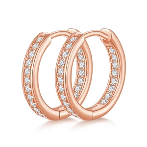 Detail of rose gold hoop earrings featuring meticulous moissanite pavé settings