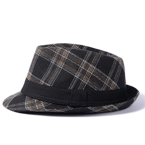 Detailed view of the plaid pattern and black ribbon on this vintage British jazz hat