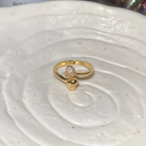 Macro shot of 18k gold plated bypass ring with micro-pave zircon and heart motif